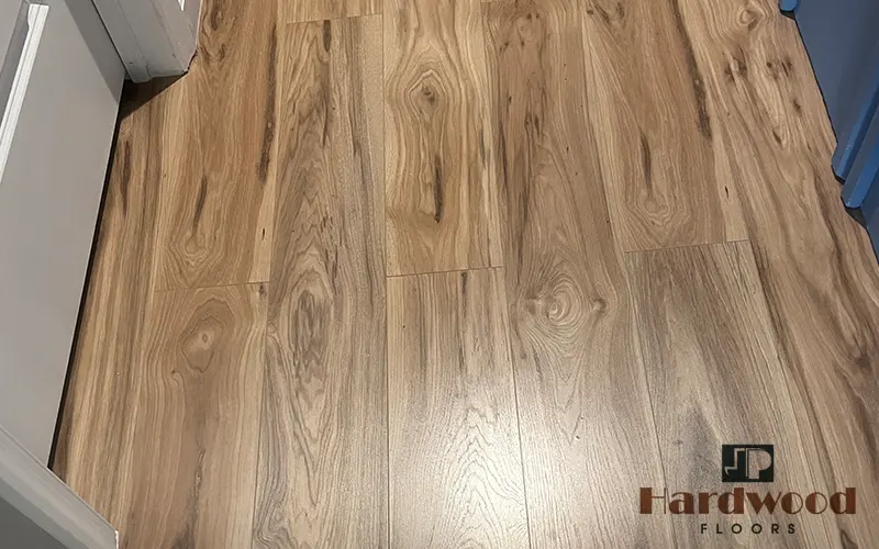 Close-up of wide plank character oak flooring showcasing rustic cathedral grain patterns by JP Hardwood Flooring.